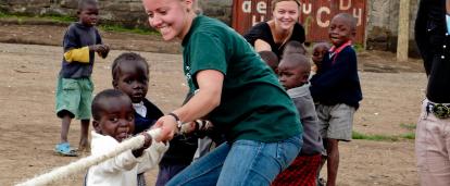 Projects Abroad volunteers work with children in Ghana. Childcare volunteer plays a game with children during her work experience in Ghana.